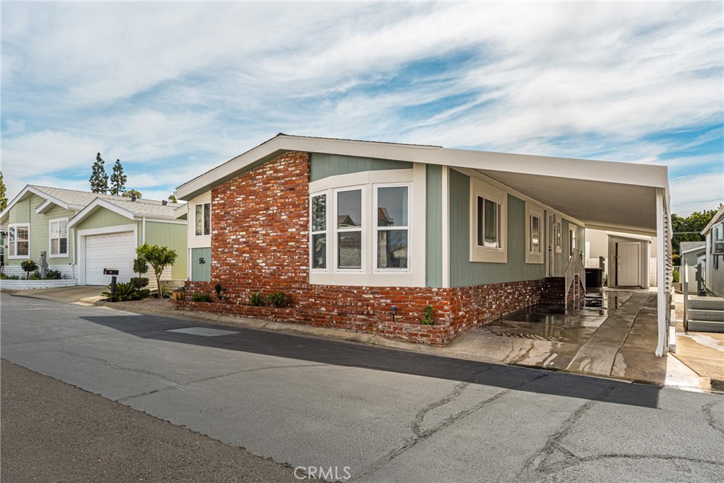 23301 Ridge Rte Drive, Unit 56 Laguna Hills, CA 92653 - Photo 35 of 44 a front view of a house with a yard