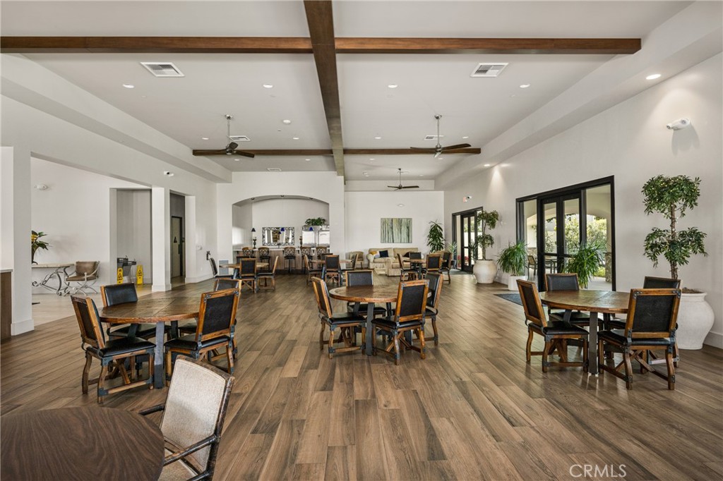 23301 Ridge Rte Drive, Unit 56 Laguna Hills, CA 92653 - Photo 38 of 44 a view of a dining room with furniture window and wooden floor