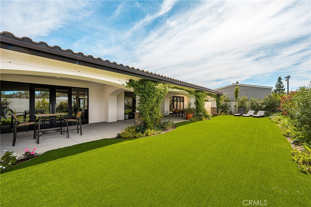 23301 Ridge Rte Drive, Unit 56 Laguna Hills, CA 92653 - Photo 41 of 44 a front view of house with a garden and patio