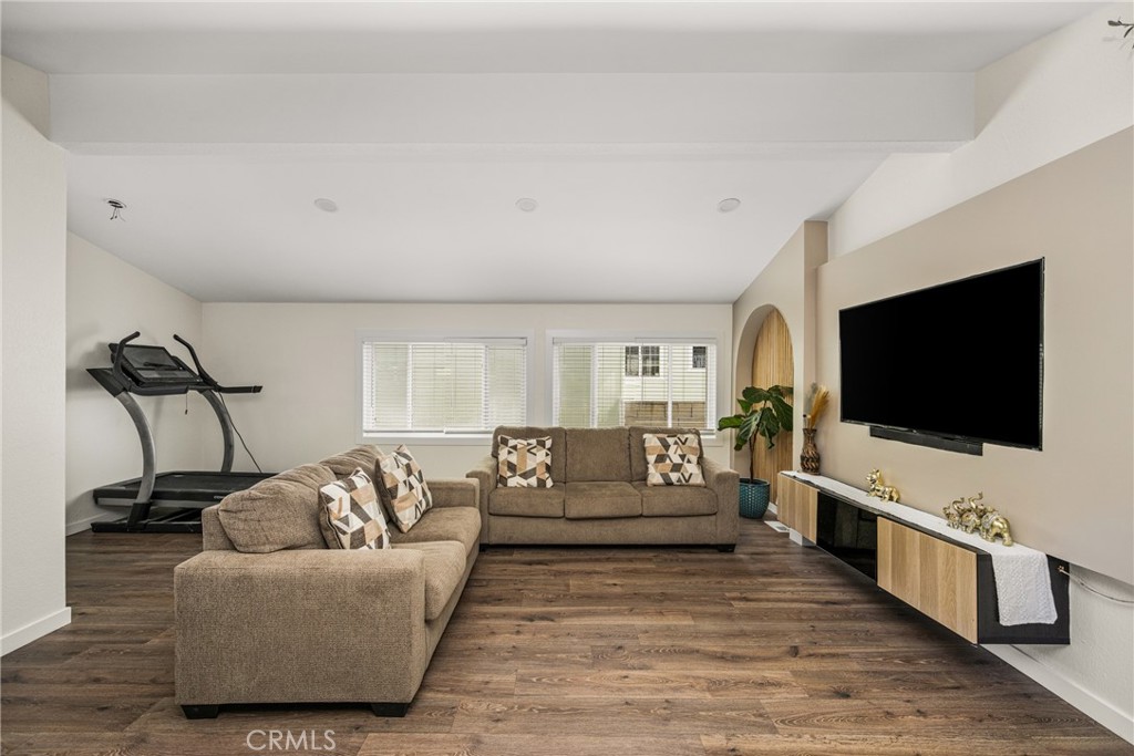 23301 Ridge Rte Drive, Unit 56 Laguna Hills, CA 92653 - Photo 8 of 44 a living room with furniture and a flat screen tv