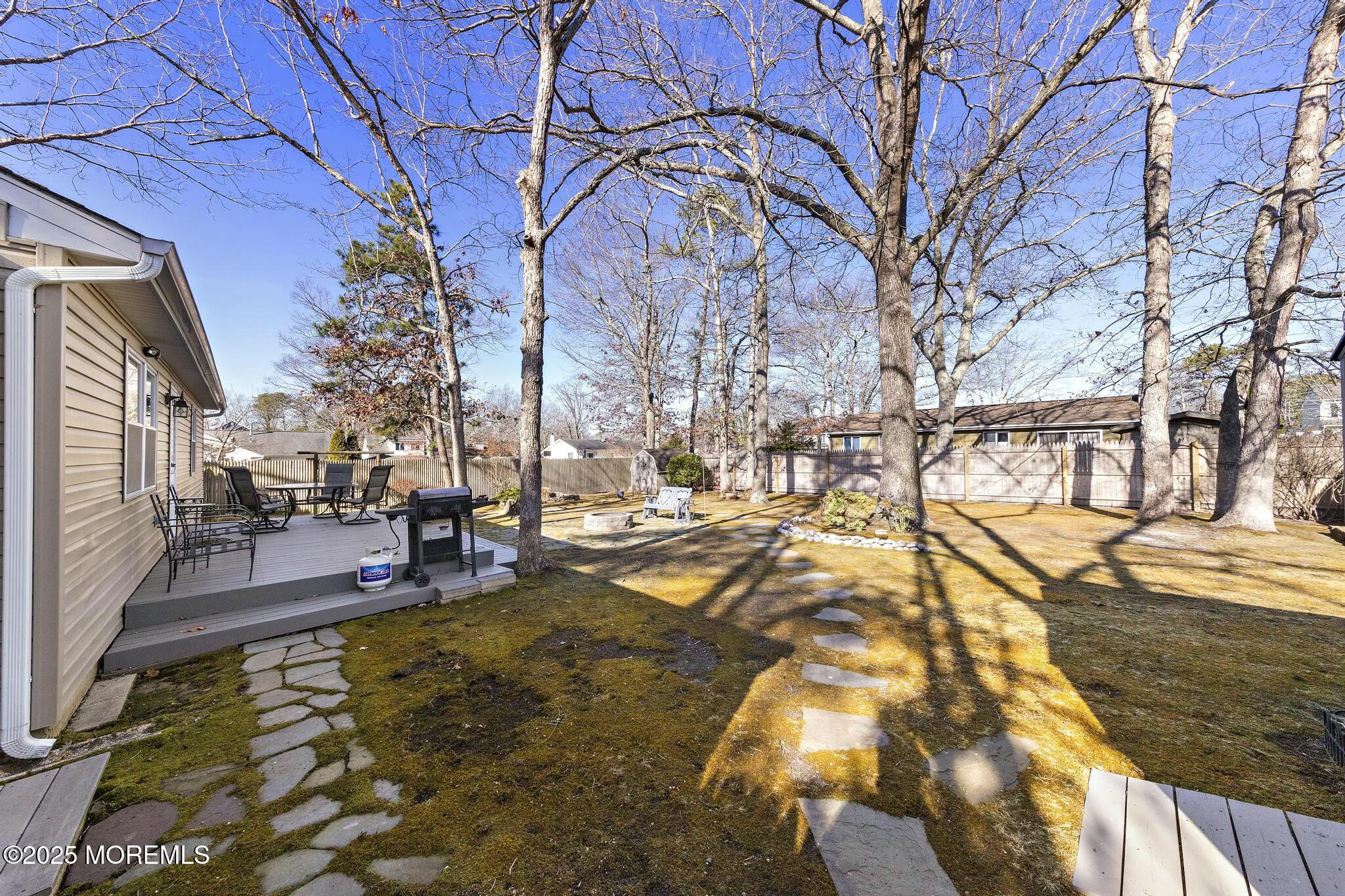 176 Riptide Avenue Manahawkin, NJ 08050 - Photo 12 of 13 a view of a yard with trees