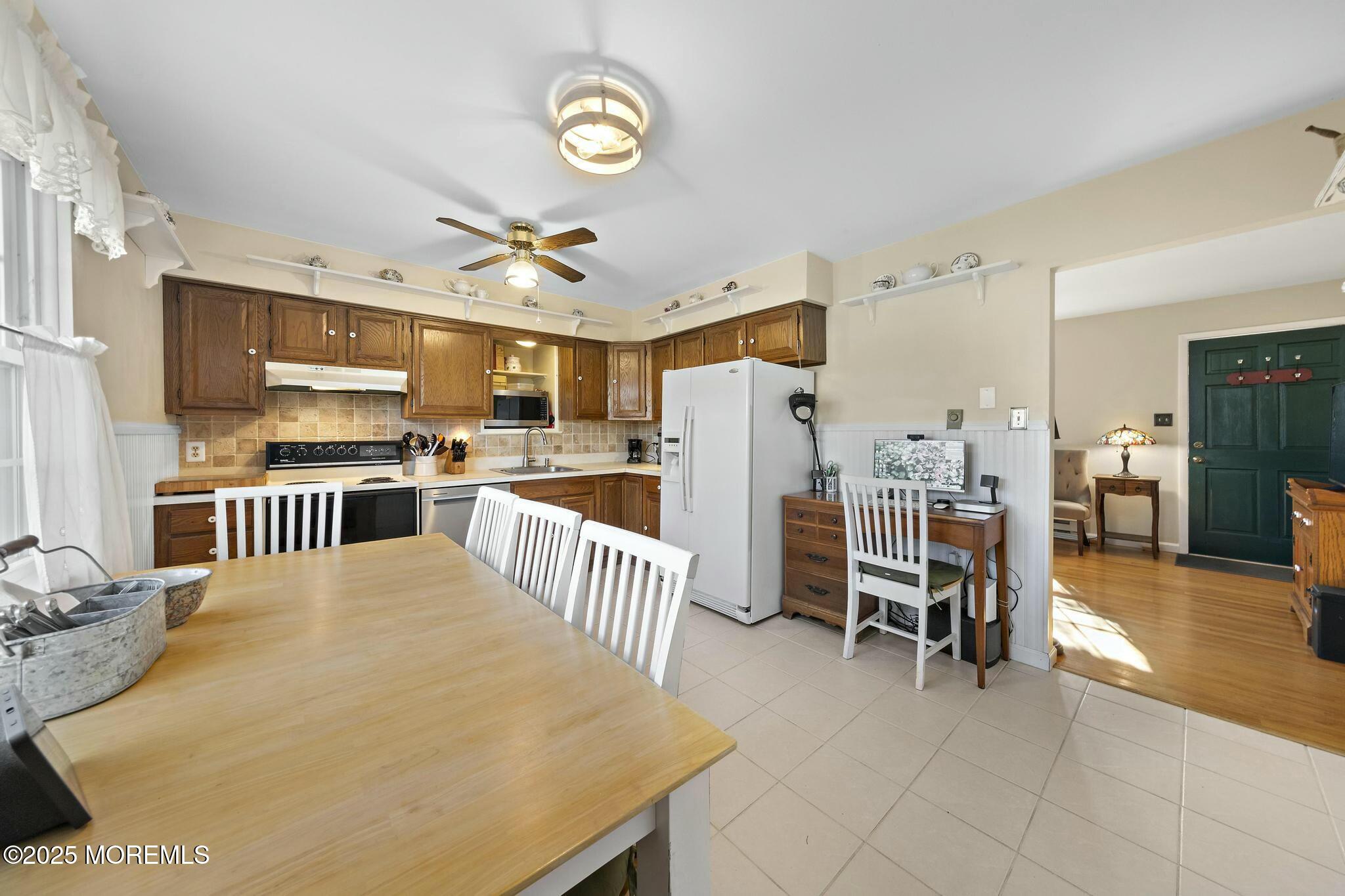 176 Riptide Avenue Manahawkin, NJ 08050 - Photo 3 of 13 a large kitchen with a table and chairs