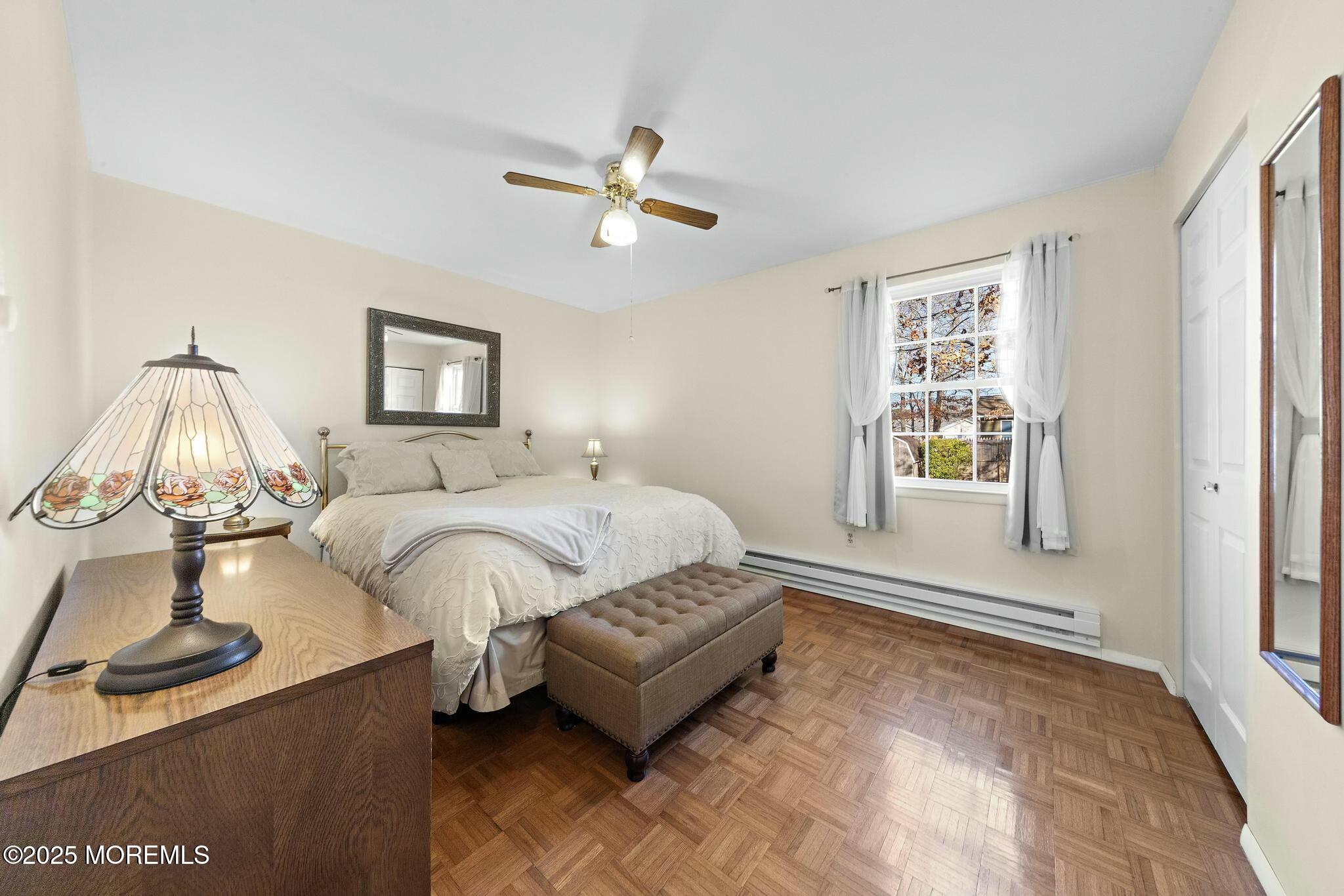 176 Riptide Avenue Manahawkin, NJ 08050 - Photo 4 of 13 a spacious bedroom with a bed and a window