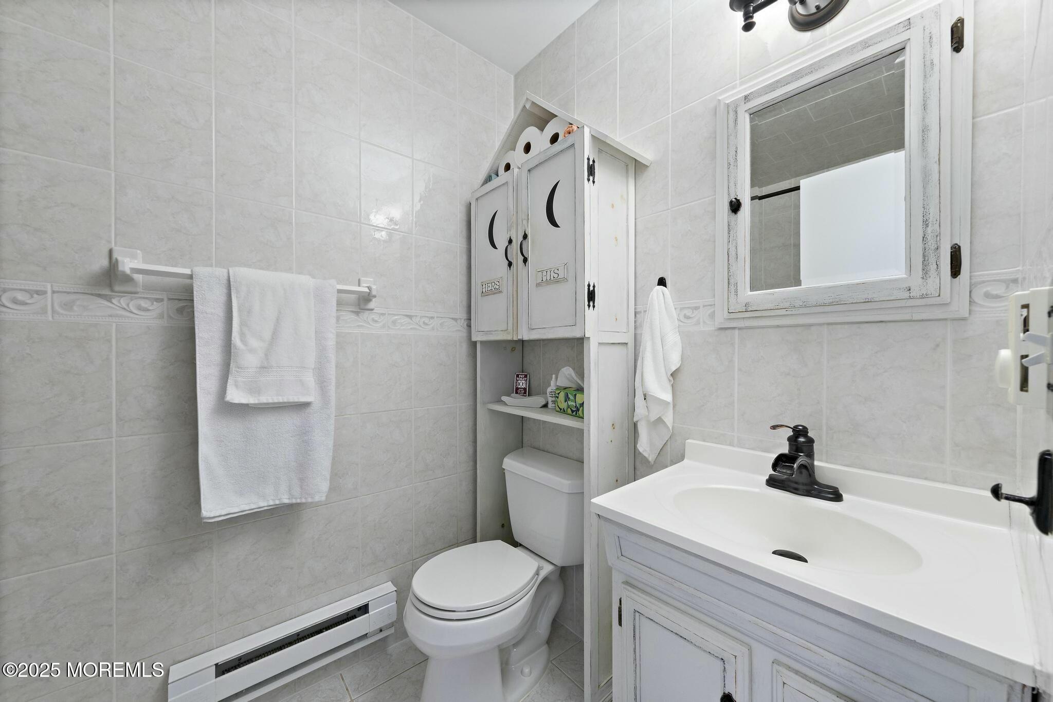 176 Riptide Avenue Manahawkin, NJ 08050 - Photo 5 of 13 a bathroom with a sink toilet and mirror