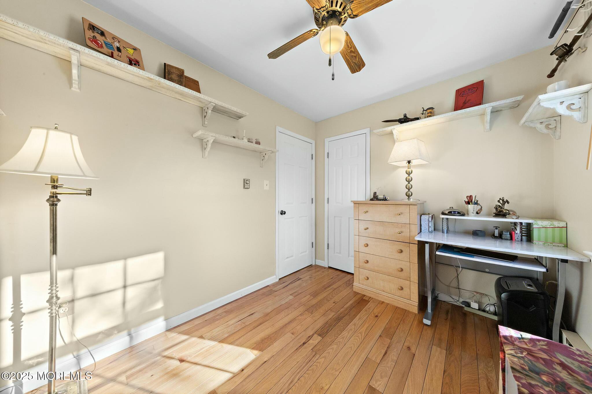 176 Riptide Avenue Manahawkin, NJ 08050 - Photo 8 of 13 a kitchen with a wooden floor and cabinets