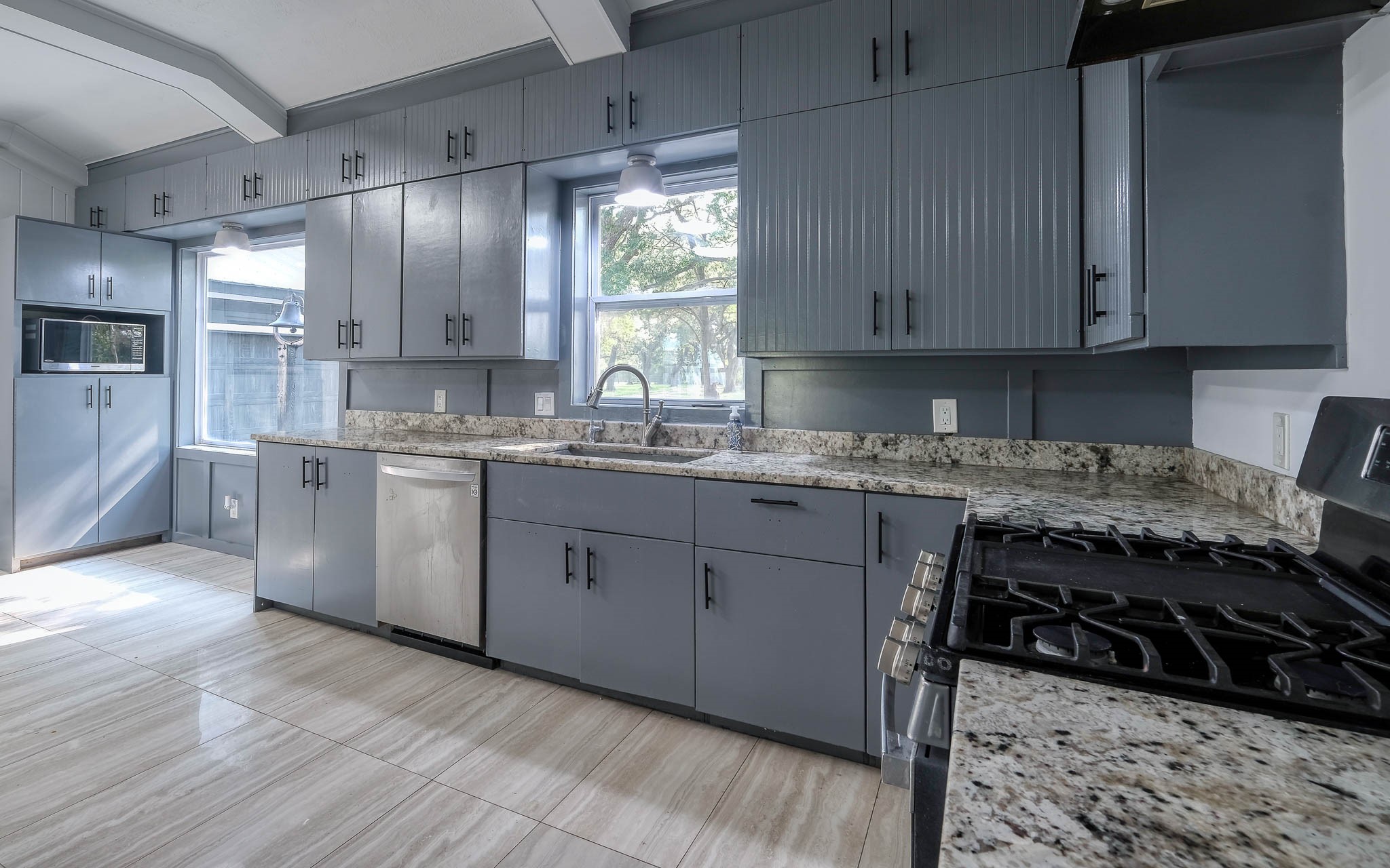 20515 Kickapoo Road Waller, TX 77484 - Photo 11 of 50 a kitchen with a stove a sink and a refrigerator