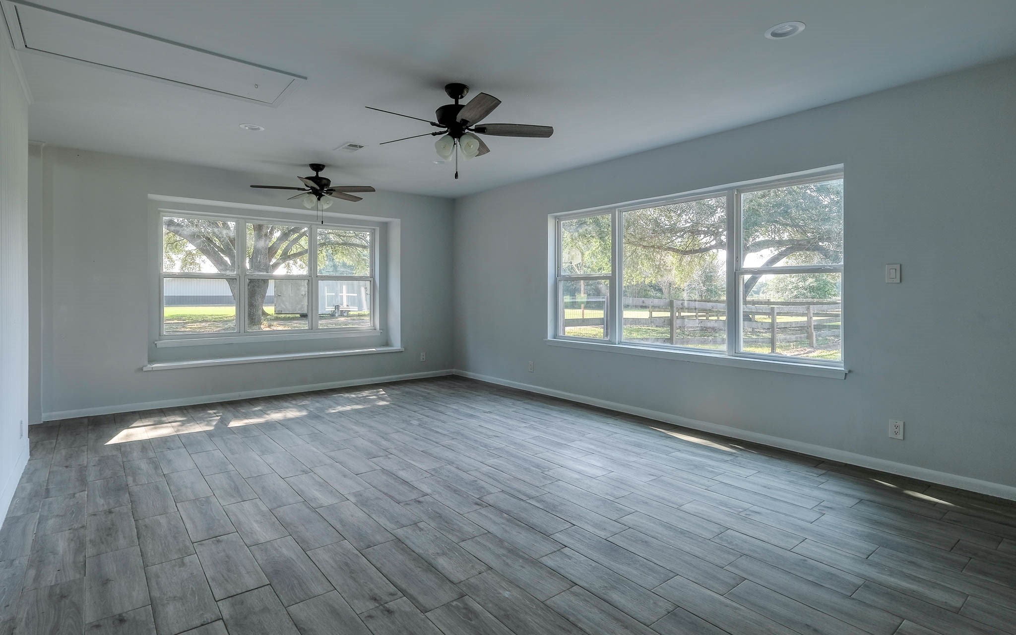 20515 Kickapoo Road Waller, TX 77484 - Photo 12 of 50 a view of an empty room with wooden floor and a window