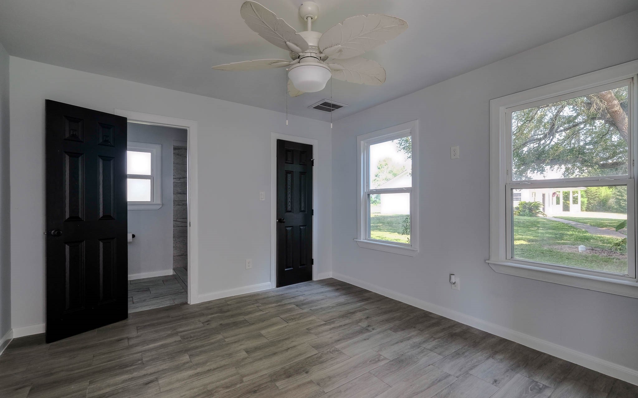 20515 Kickapoo Road Waller, TX 77484 - Photo 22 of 50 a view of an empty room with wooden floor and a window