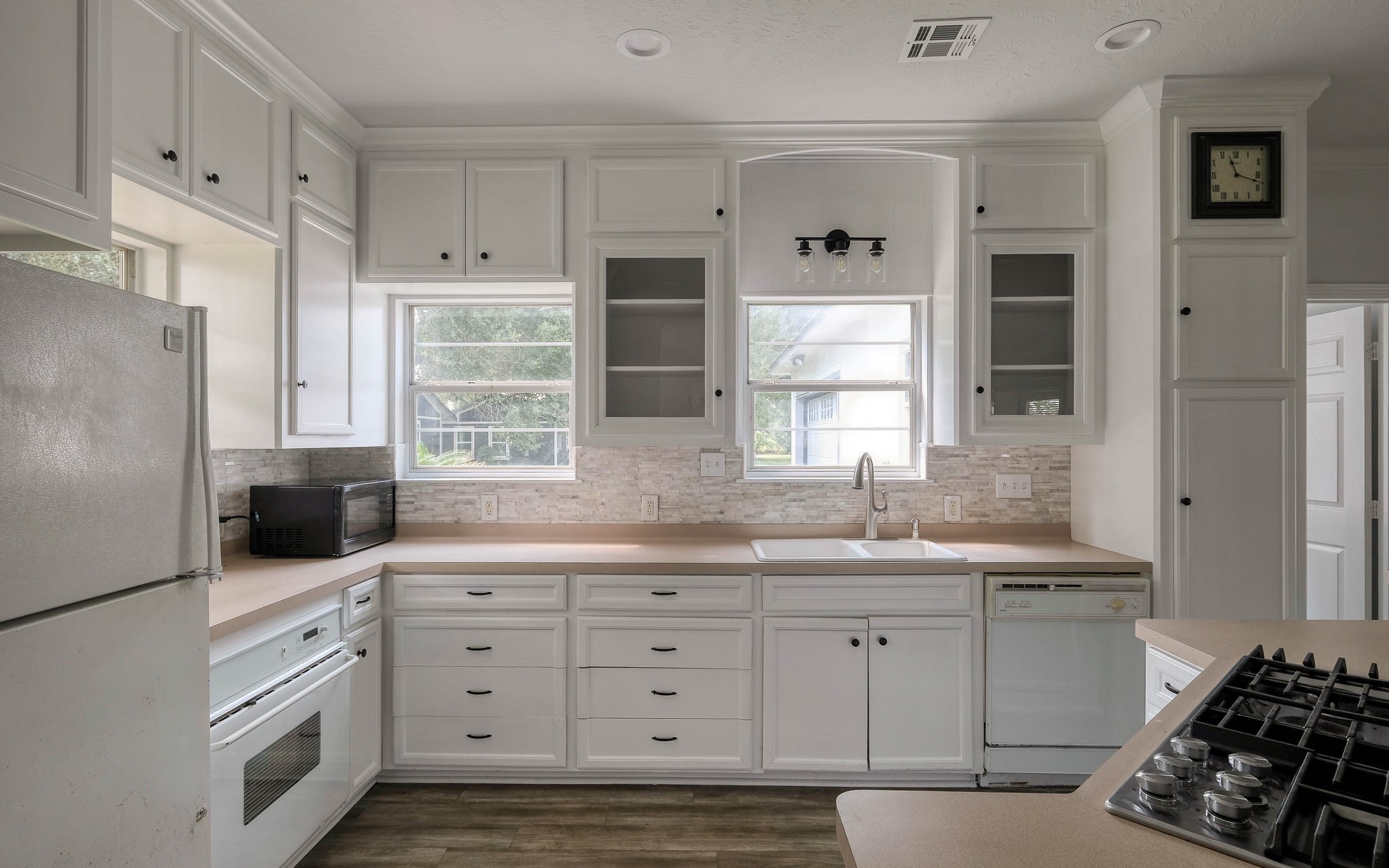 20515 Kickapoo Road Waller, TX 77484 - Photo 34 of 50 a kitchen with white cabinets and appliances