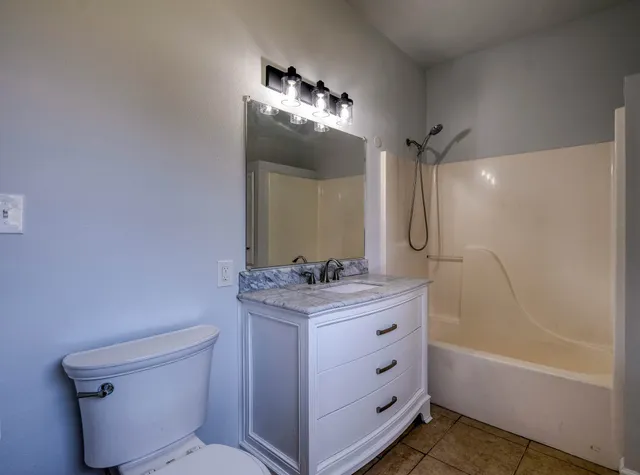 a utility room with cabinets washer and dryer