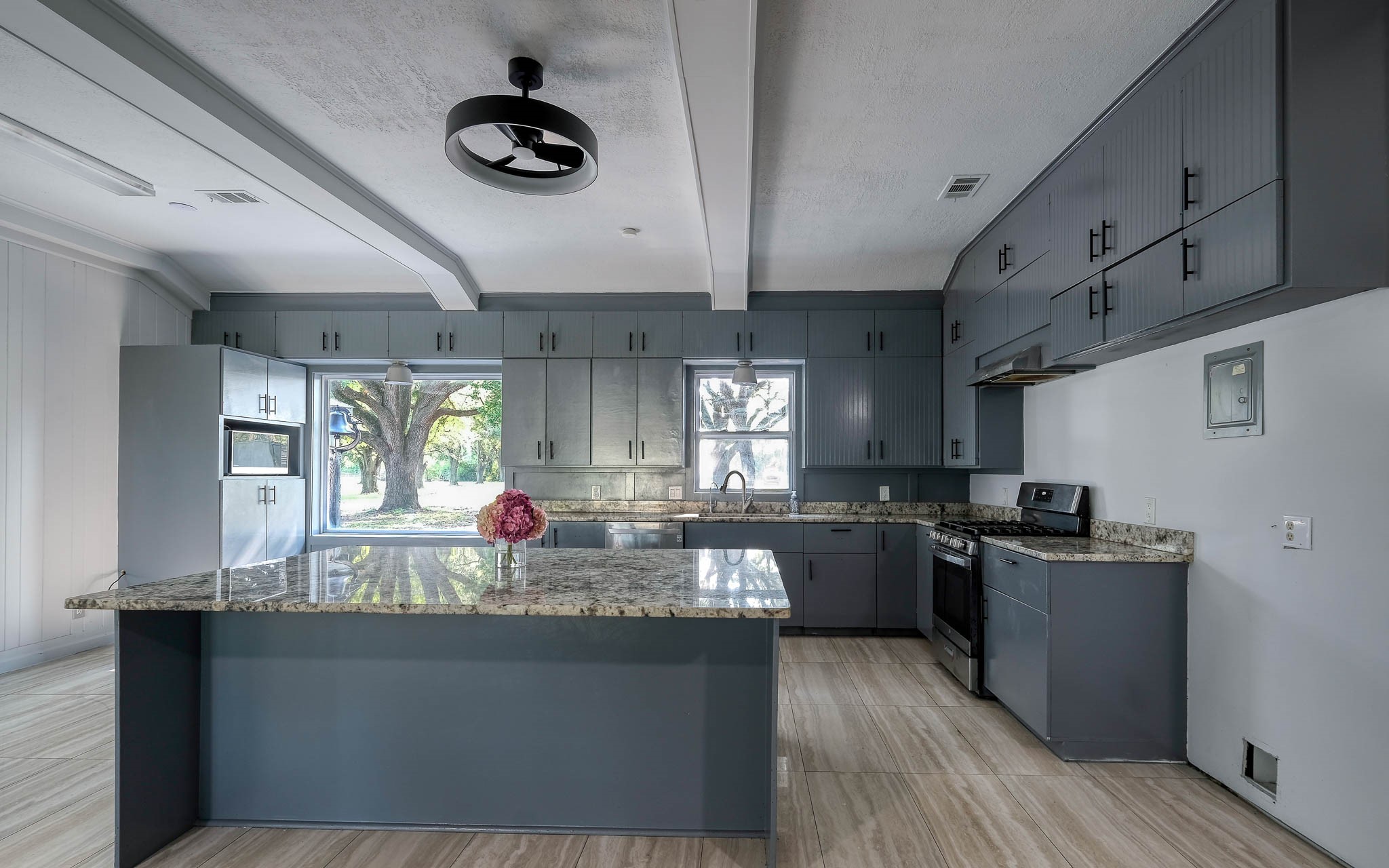 20515 Kickapoo Road Waller, TX 77484 - Photo 8 of 50 a kitchen with stainless steel appliances granite countertop a sink dishwasher stove and wooden cabinets