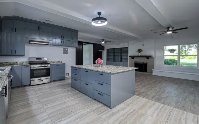 a kitchen with stainless steel appliances granite countertop a stove and a refrigerator