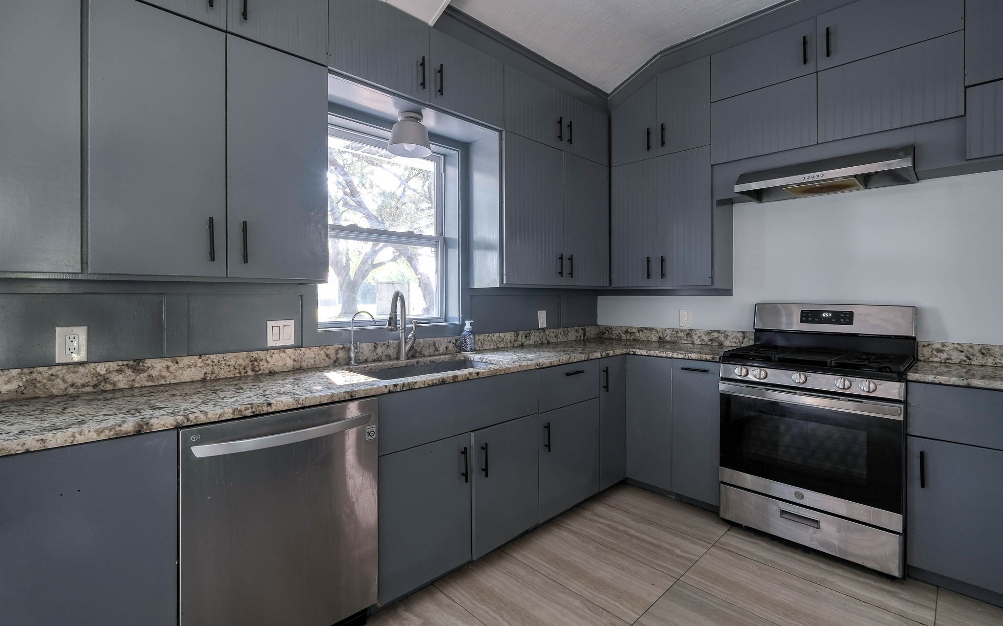 20515 Kickapoo Road Waller, TX 77484 - Photo 10 of 50 a kitchen with stainless steel appliances granite countertop a sink a stove and a microwave