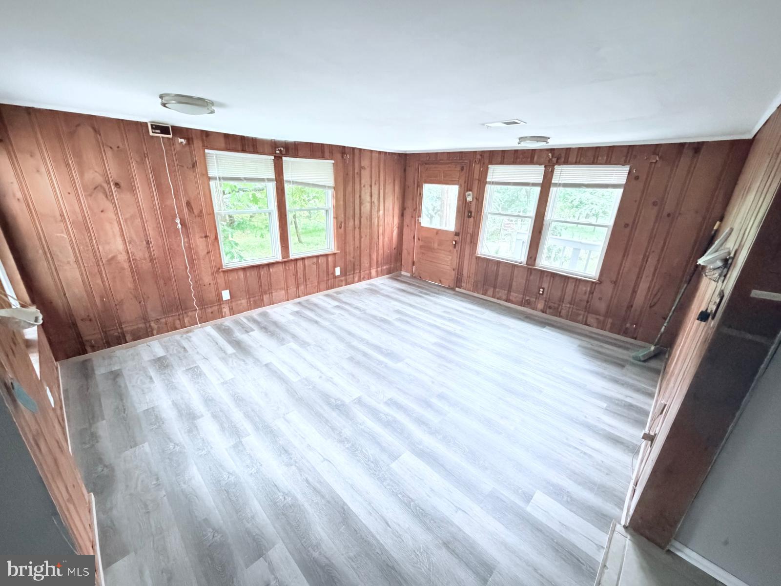 7315 Oxon Hill Road Oxon Hill, MD 20745 - Photo 3 of 12 a view of an empty room with wooden floor and a window