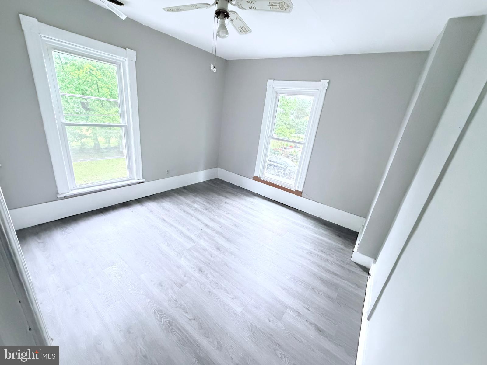 7315 Oxon Hill Road Oxon Hill, MD 20745 - Photo 6 of 12 a view of an empty room with wooden floor and a window