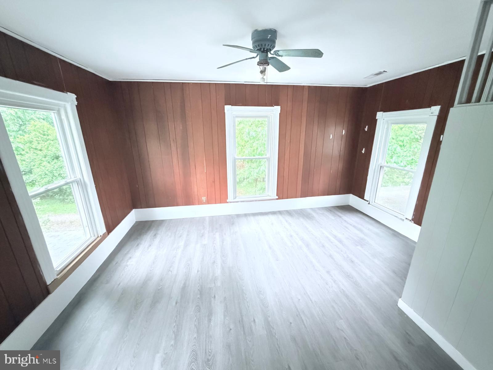 7315 Oxon Hill Road Oxon Hill, MD 20745 - Photo 9 of 12 a view of an empty room with a window and wooden floor