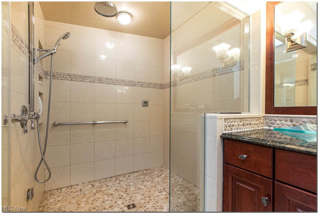 2878 Brighton Road Cleveland, OH 44120 - Photo 24 of 35 Fabulous Owner's suite with THREE walk-in closets that are amazing and glamour bath with heated tile floors, custom cherry cabinets, two vanities/dressing areas and over-sized steam shower