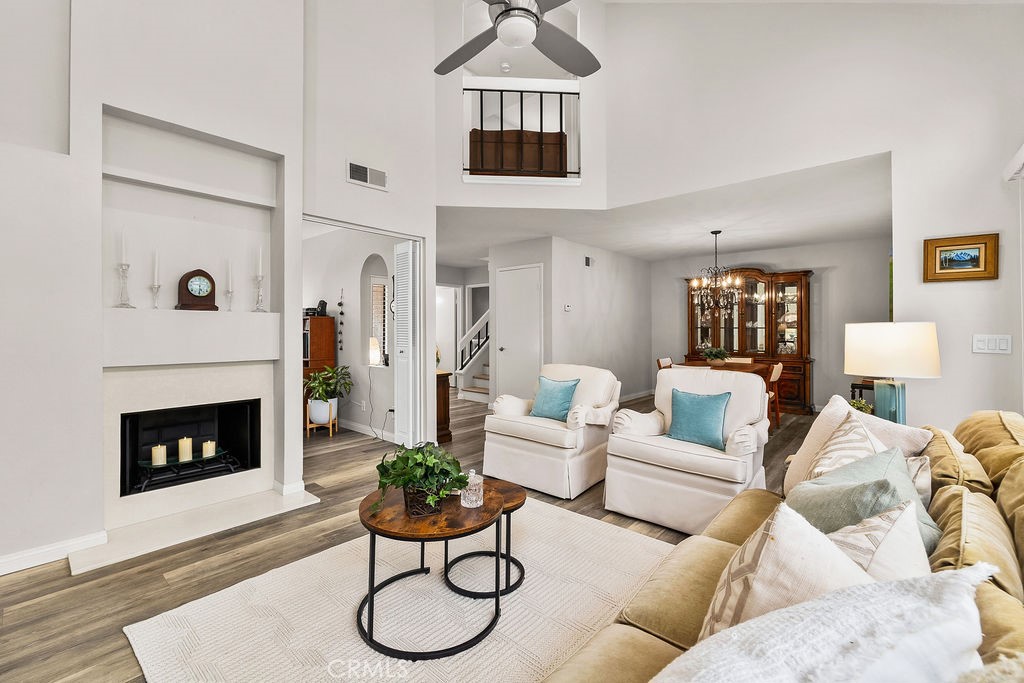 38 Navarre, Unit 138 Irvine, CA 92612 - Photo 12 of 33 a living room with furniture a flat screen tv and a fireplace