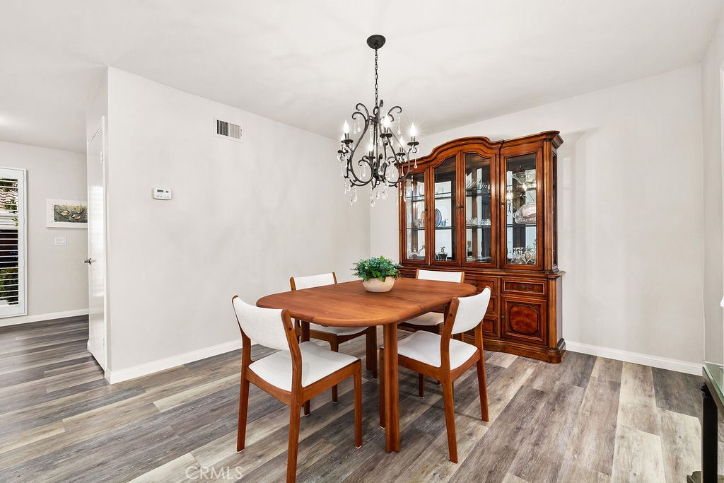 38 Navarre, Unit 138 Irvine, CA 92612 - Photo 15 of 33 a dining room with furniture a chandelier and wooden floor