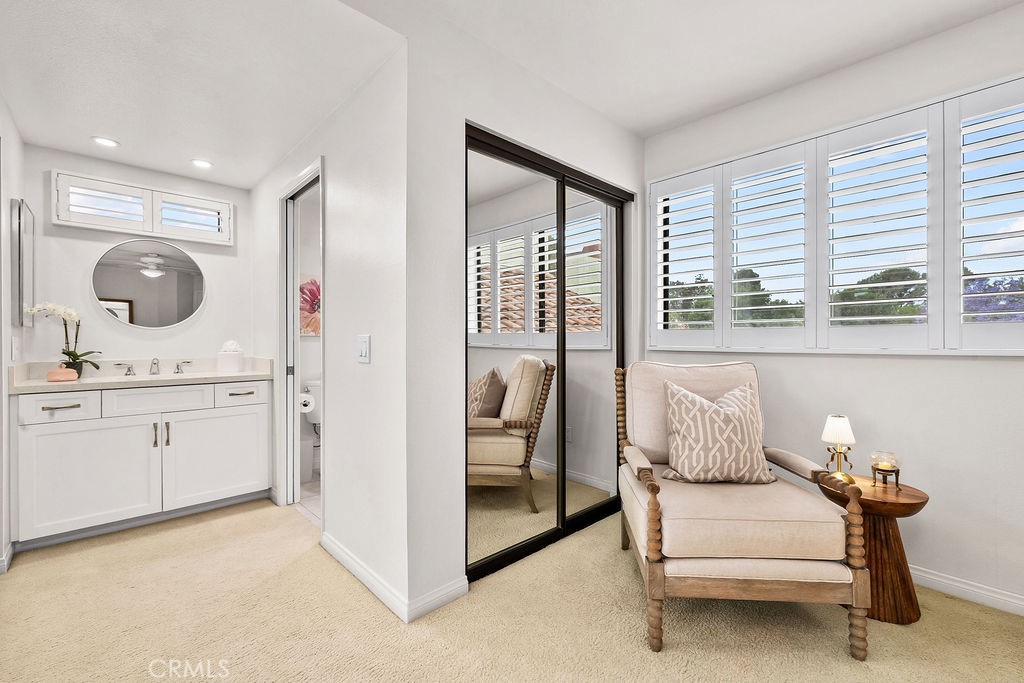 38 Navarre, Unit 138 Irvine, CA 92612 - Photo 25 of 33 a en suite bathroom with a granite countertop sink and a mirror