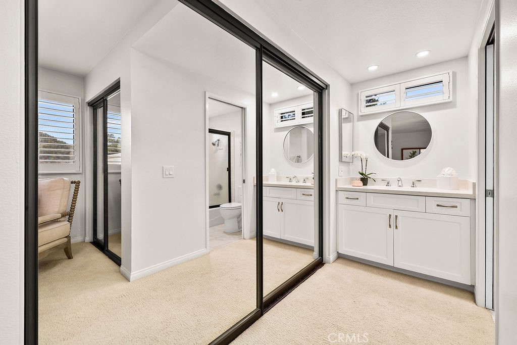 38 Navarre, Unit 138 Irvine, CA 92612 - Photo 26 of 33 a en suite bathroom with a granite countertop sink mirror and shower