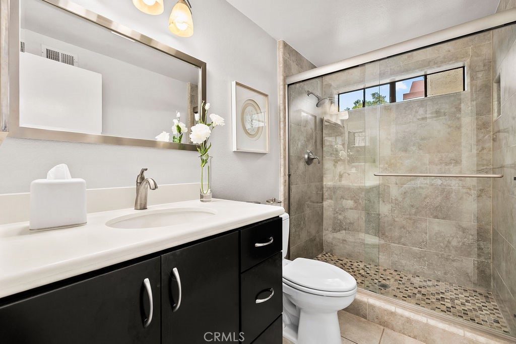 38 Navarre, Unit 138 Irvine, CA 92612 - Photo 30 of 33 a bathroom with a sink a toilet and shower