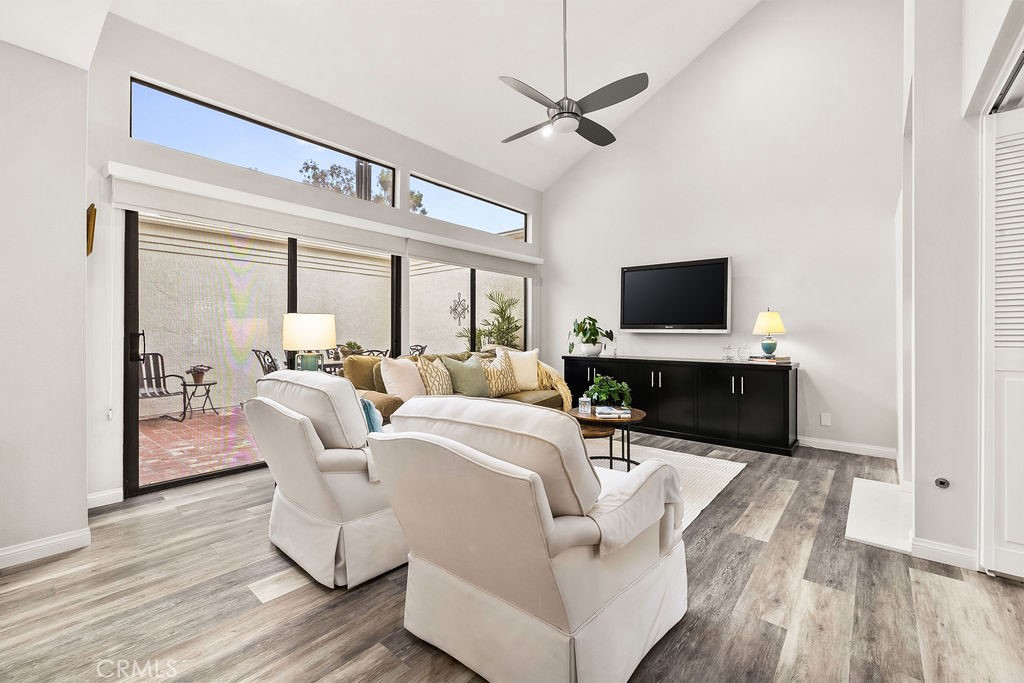 38 Navarre, Unit 138 Irvine, CA 92612 - Photo 7 of 33 a living room with furniture a fireplace and a flat screen tv