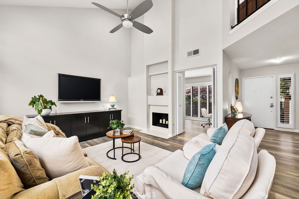 38 Navarre, Unit 138 Irvine, CA 92612 - Photo 10 of 33 a living room with furniture a flat screen tv and a fireplace