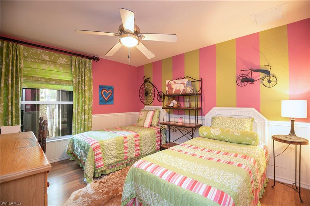 1207 Imperial Drive Naples, FL 34110 - Photo 10 of 15 a bedroom with two beds and a chandelier