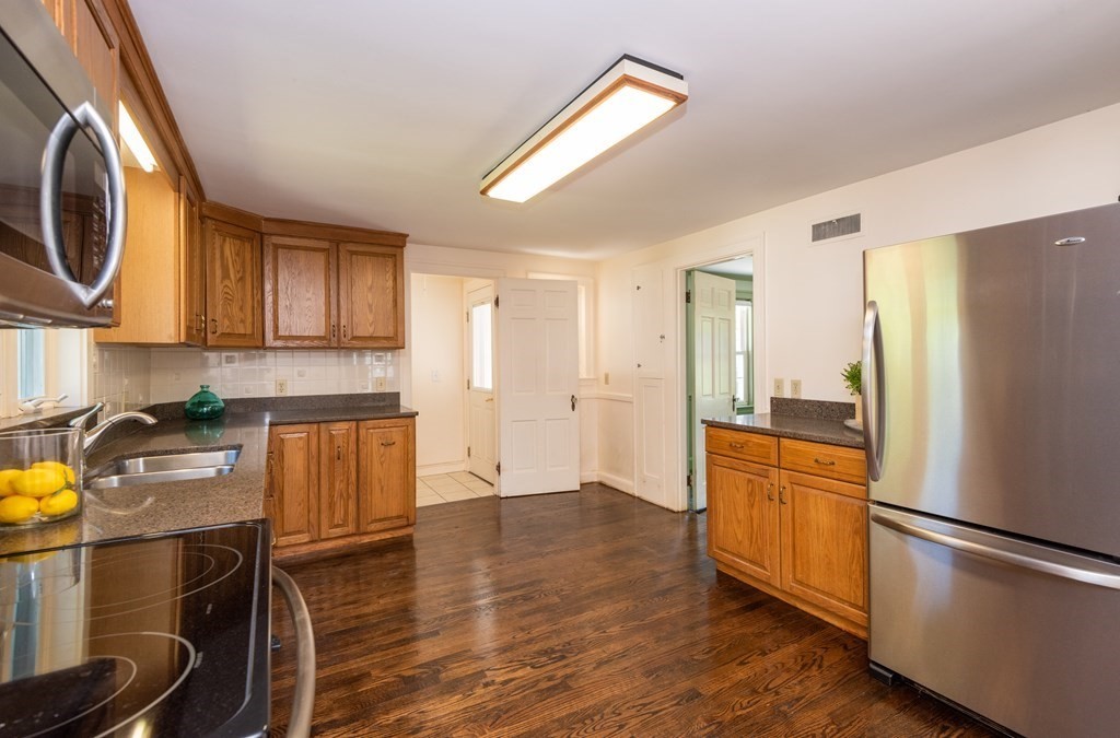 81 Fairview Avenue Lynnfield, MA 01940 - Photo 21 of 41 a kitchen with a refrigerator a stove top oven a sink and dishwasher