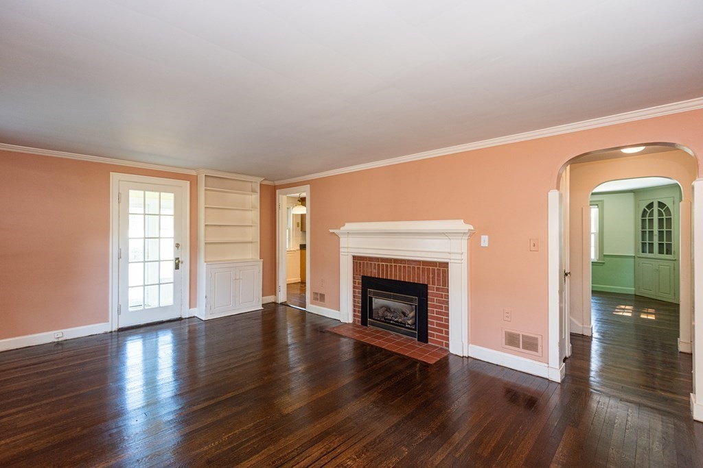 81 Fairview Avenue Lynnfield, MA 01940 - Photo 9 of 41 an empty room with wooden floor fireplace and windows