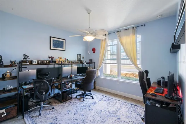 a view of a workspace with furniture and a window