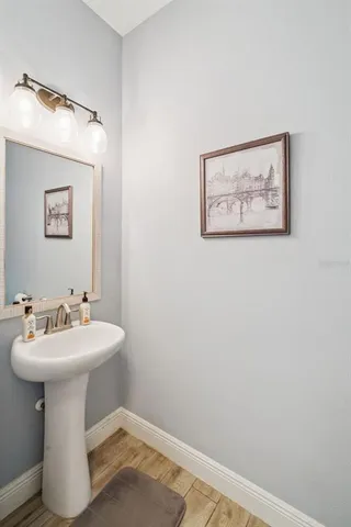 a bathroom with a sink mirror and toilet