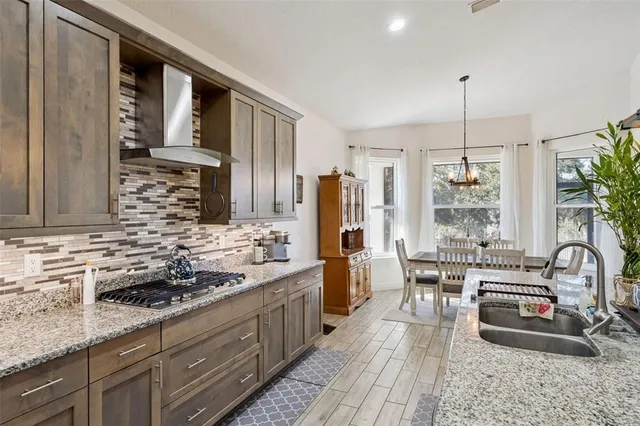 a kitchen with sink stove and refrigerator