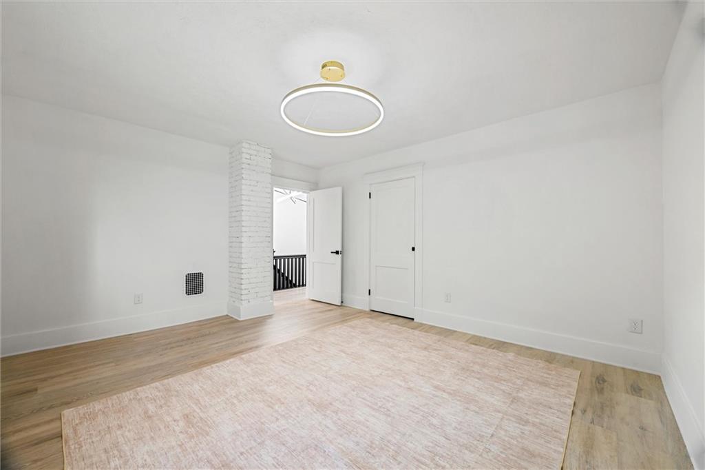 56 Bascom Avenue Pittsburgh, PA 15214 - Photo 17 of 46 an empty room with wooden floor and windows