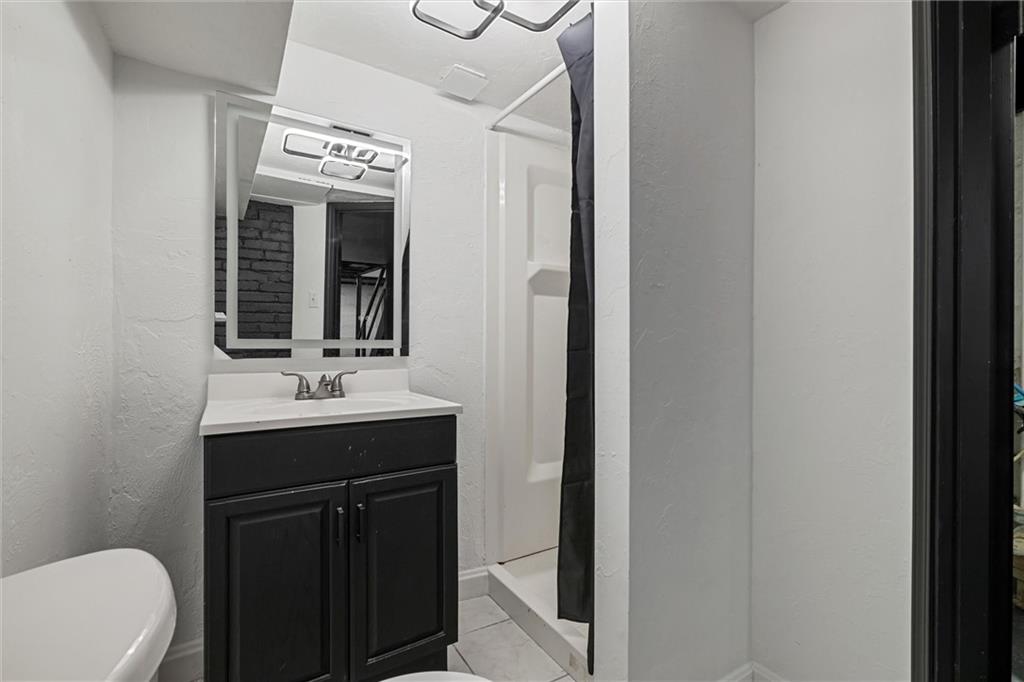 56 Bascom Avenue Pittsburgh, PA 15214 - Photo 26 of 46 a bathroom with a double vanity sink and a mirror