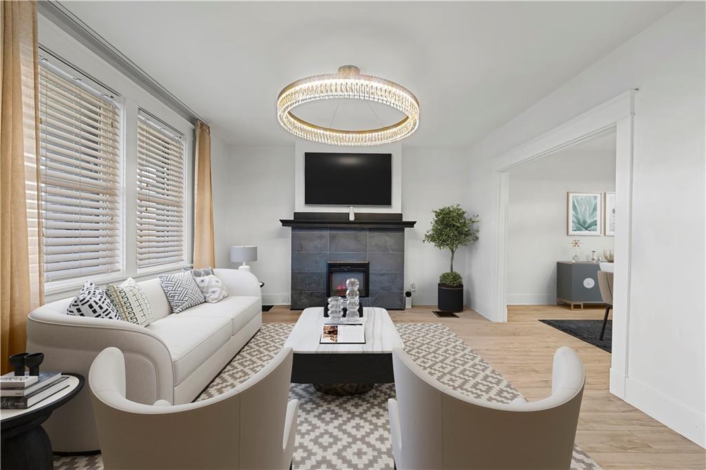 56 Bascom Avenue Pittsburgh, PA 15214 - Photo 3 of 46 a living room with furniture a fireplace and a flat screen tv