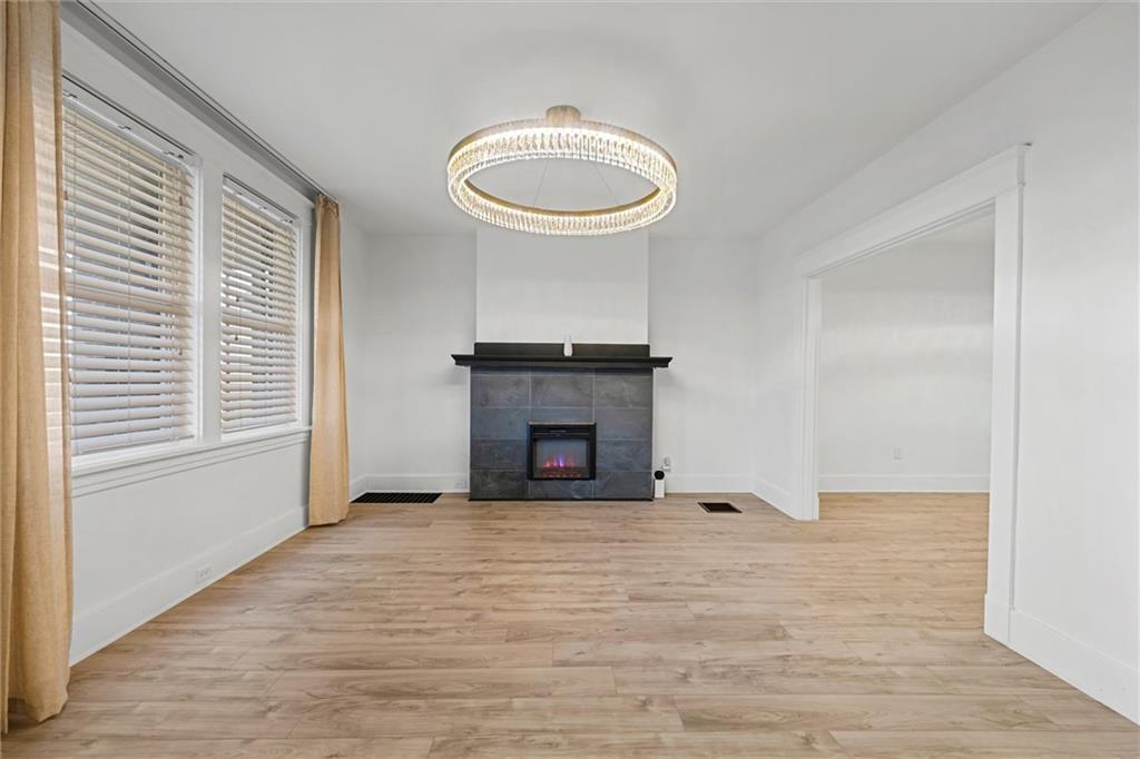 56 Bascom Avenue Pittsburgh, PA 15214 - Photo 4 of 46 a view of an empty room with a fireplace and a window