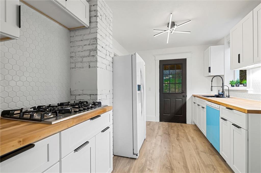 56 Bascom Avenue Pittsburgh, PA 15214 - Photo 10 of 46 a kitchen with stainless steel appliances a stove a sink and a refrigerator