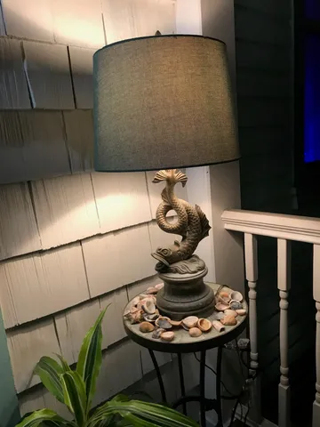 a dining room with furniture and a floor to ceiling window