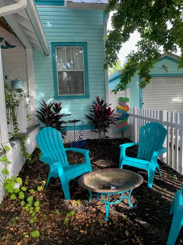 a view of a patio with table and chairs potted plants with wooden floor