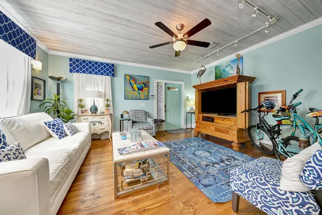 a spacious bedroom with a large bed and a flat tv screen