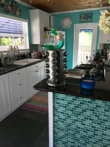 a view of a patio with table and chairs potted plants