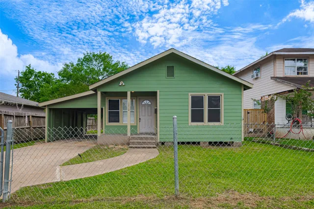 a front view of a house with a yard and porch