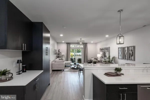 a kitchen with stainless steel appliances granite countertop a sink a stove top oven a refrigerator and dishwasher
