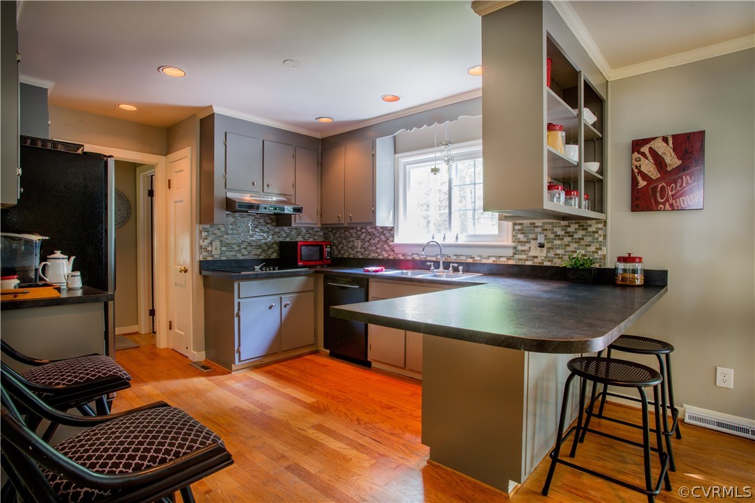 10301 Apache Road Richmond, VA 23235 - Photo 5 of 24 a kitchen with stainless steel appliances kitchen island granite countertop a refrigerator a sink a stove and chairs