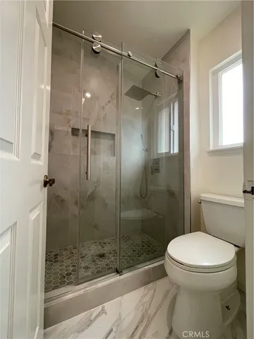 a bathroom with a toilet and shower