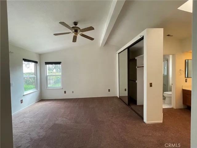 a view of empty room with ceiling fan