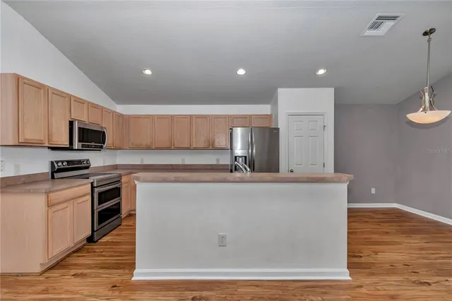 a view of a kitchen with microwave and cabinets
