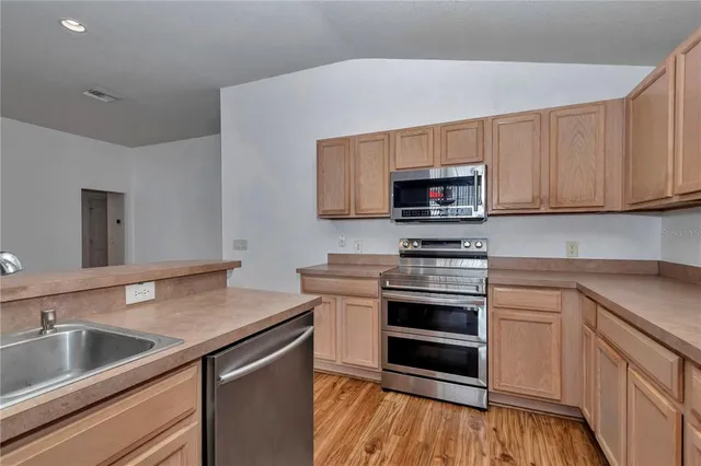 a kitchen with a sink stove and microwave